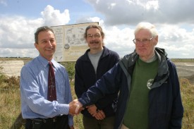 Gilbert Green from Wiltshire Geology Group with quarry managers unveiling an information board at a Wiltshire quarry.