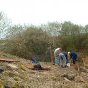 Building a viewing platform on a slope opposite the rock face.