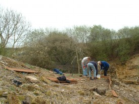 Building a viewing platform on a slope opposite the rock face.