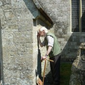 Assessing building stones at Chilmark Church, Wiltshire. Chilmark Stone is famous for its use in Salisbury Cathedral.